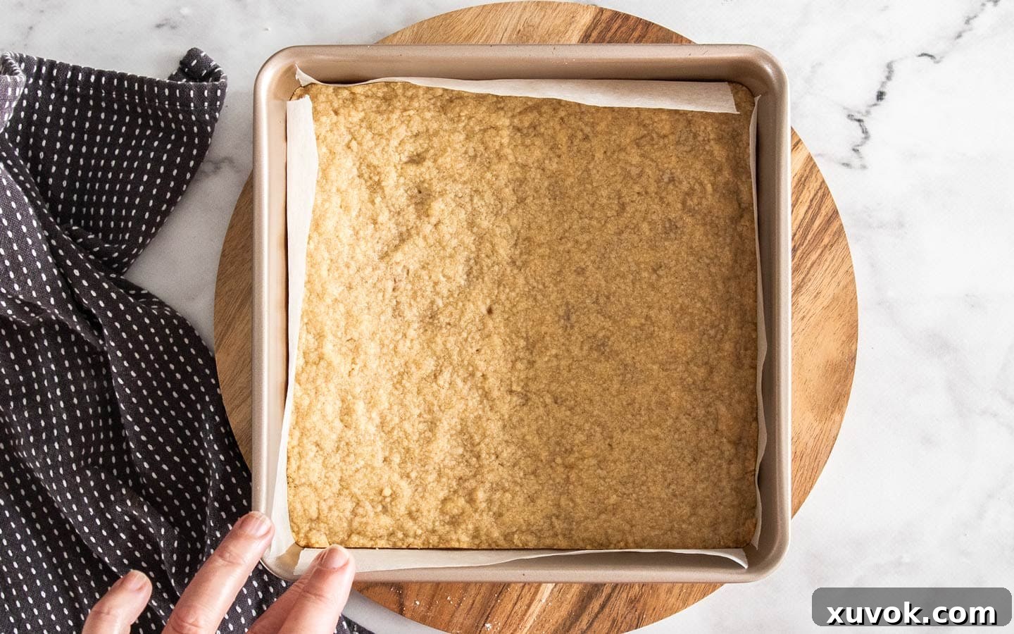 The shortbread base after its initial baking, golden and ready for the filling.