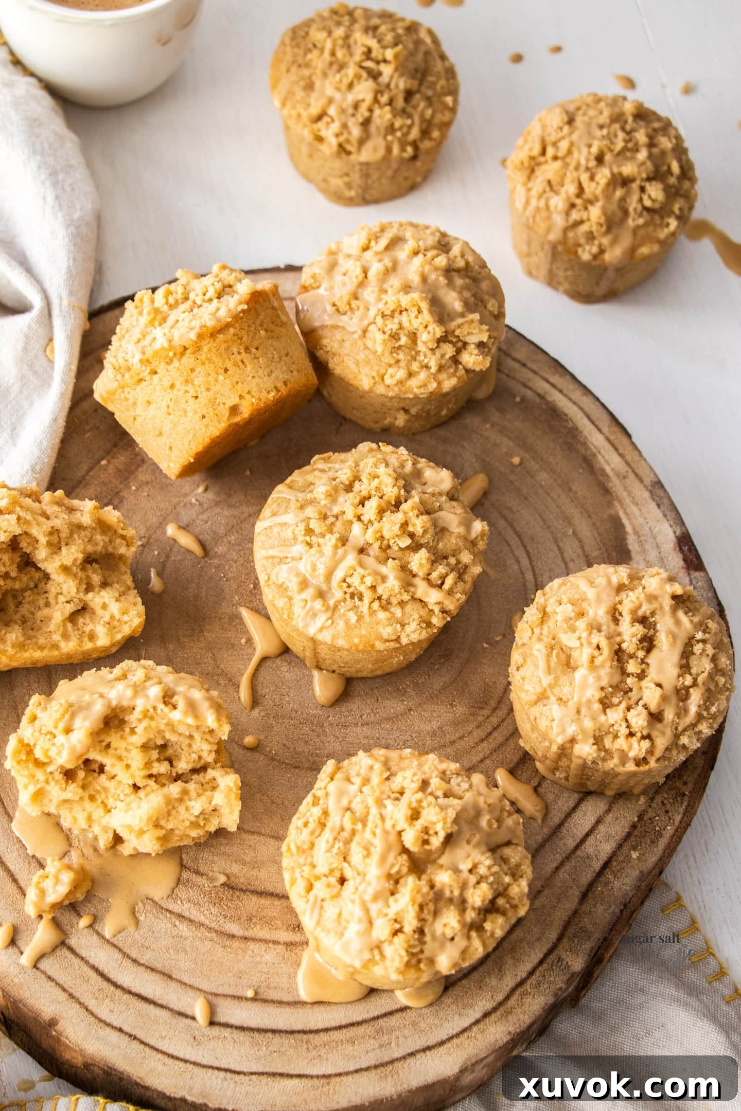 Top down view of a batch of crumble topped muffins.