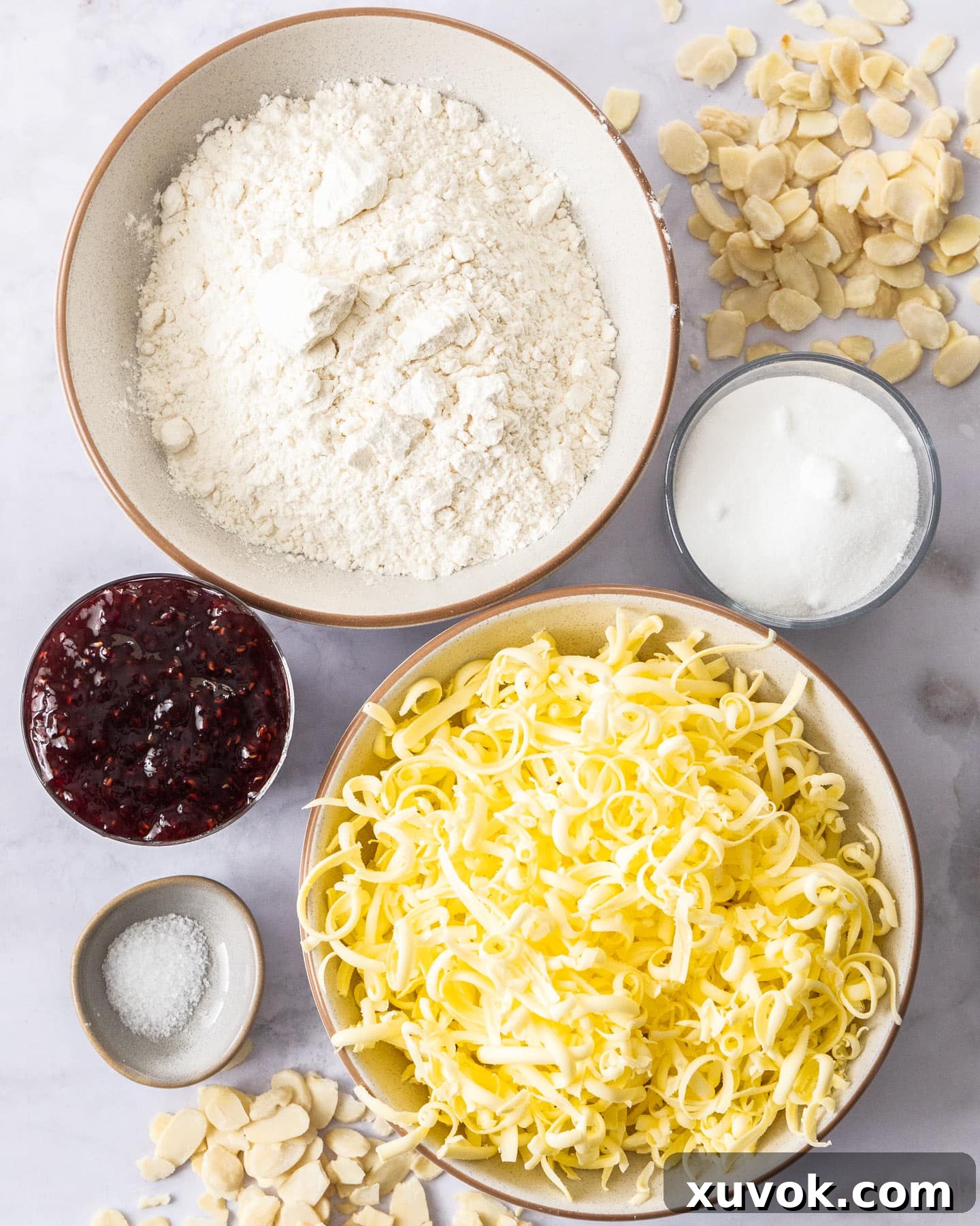 Ingredients for raspberry shortbread bars laid out on a surface.
