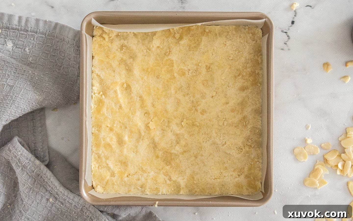 The shortbread mixture pressed firmly into the base of the pan, ready for baking.