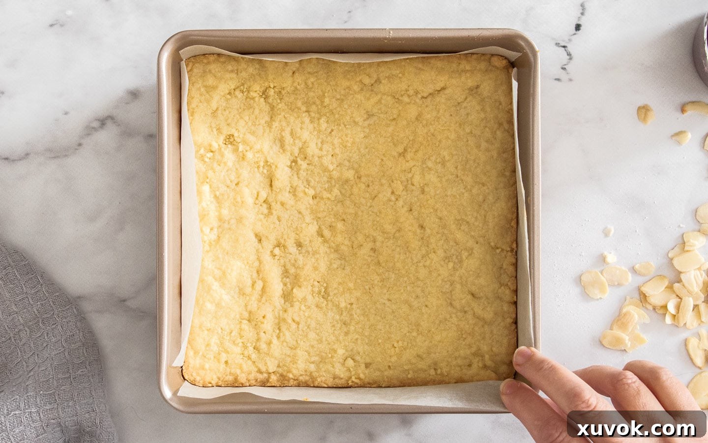 The shortbread base after it has been pre-baked, showing golden edges.