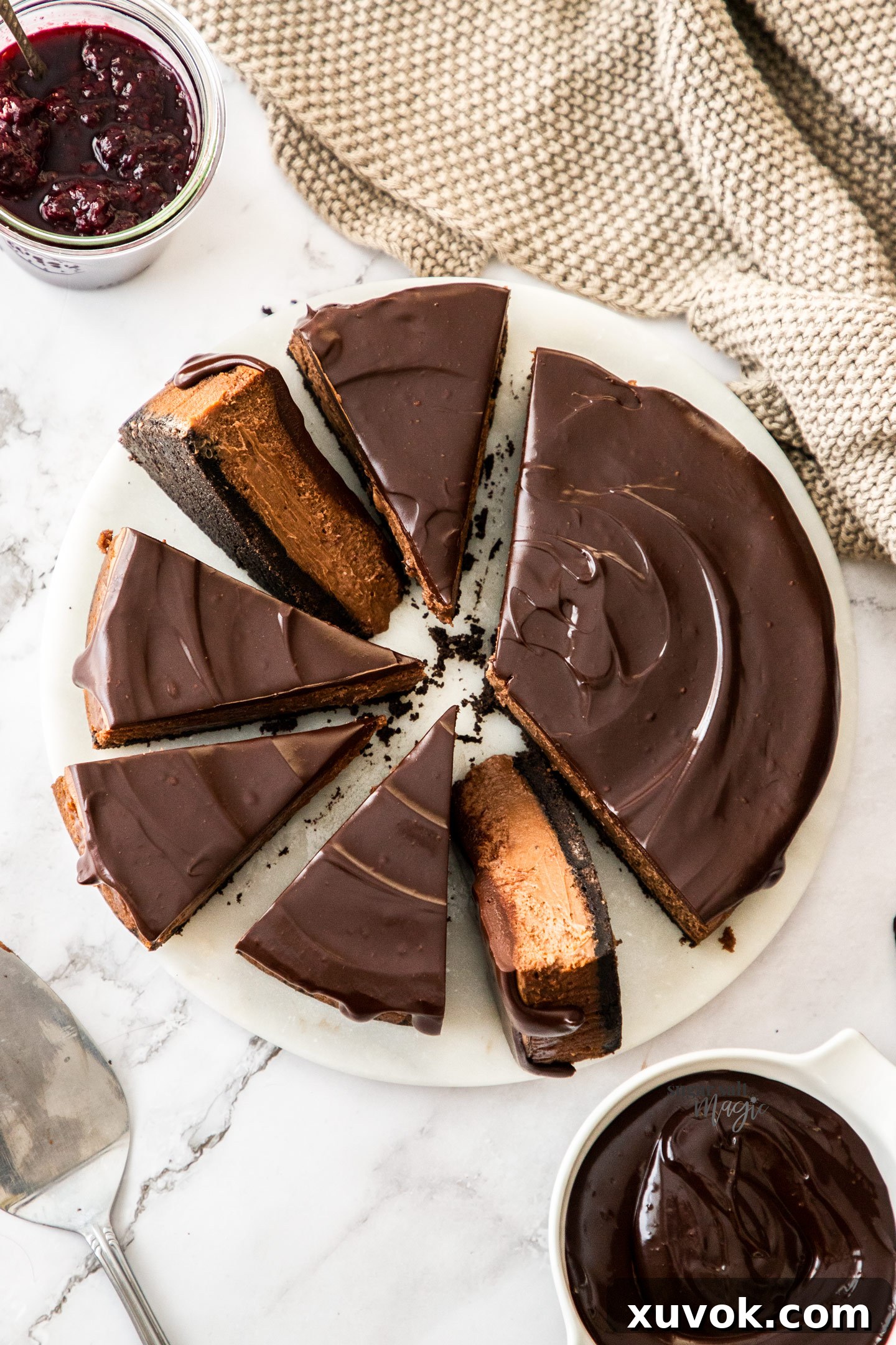 Top down view of a chocolate cheesecake cut into slices.