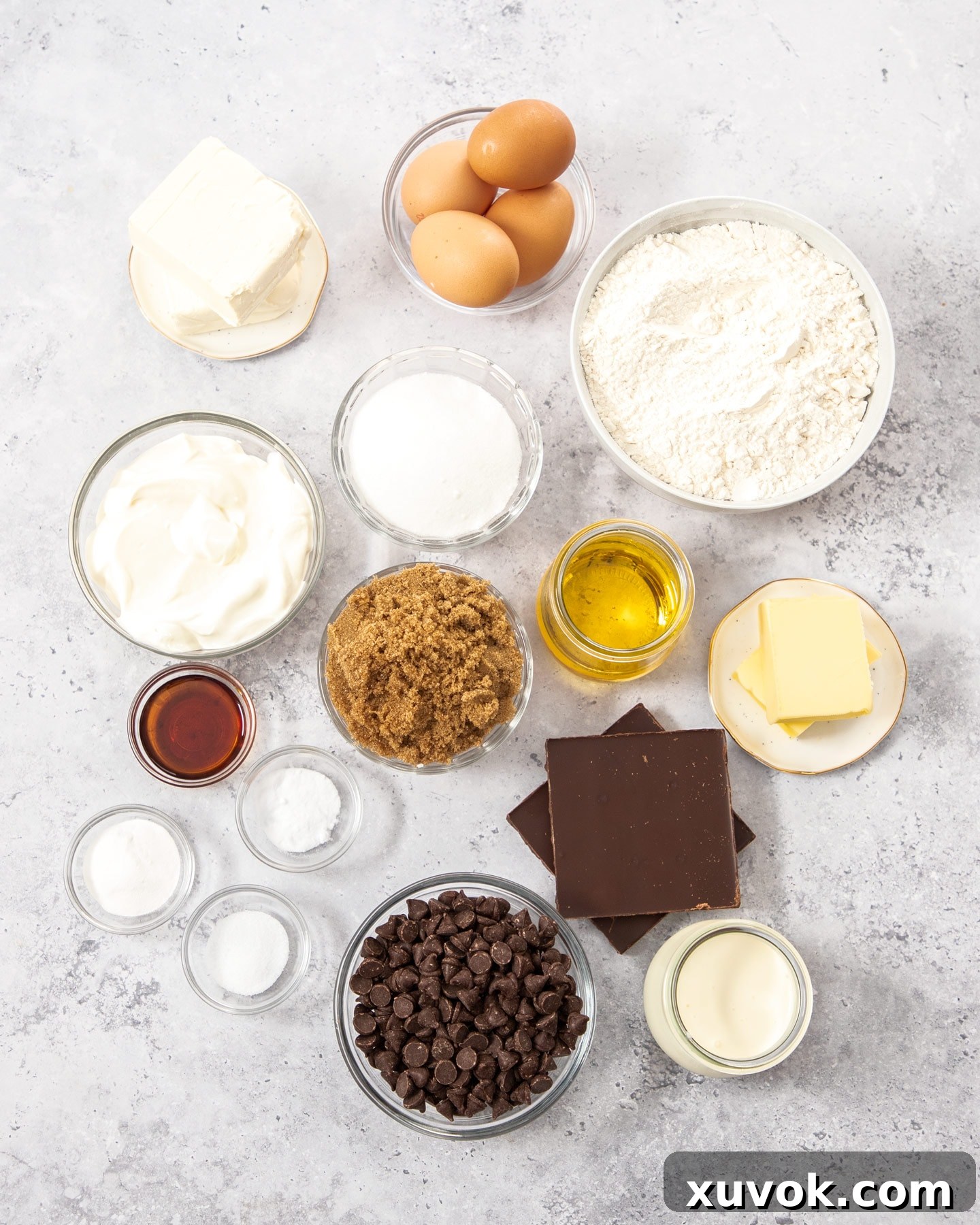 Ingredients for chocolate chip bundt cake on a gray surface.