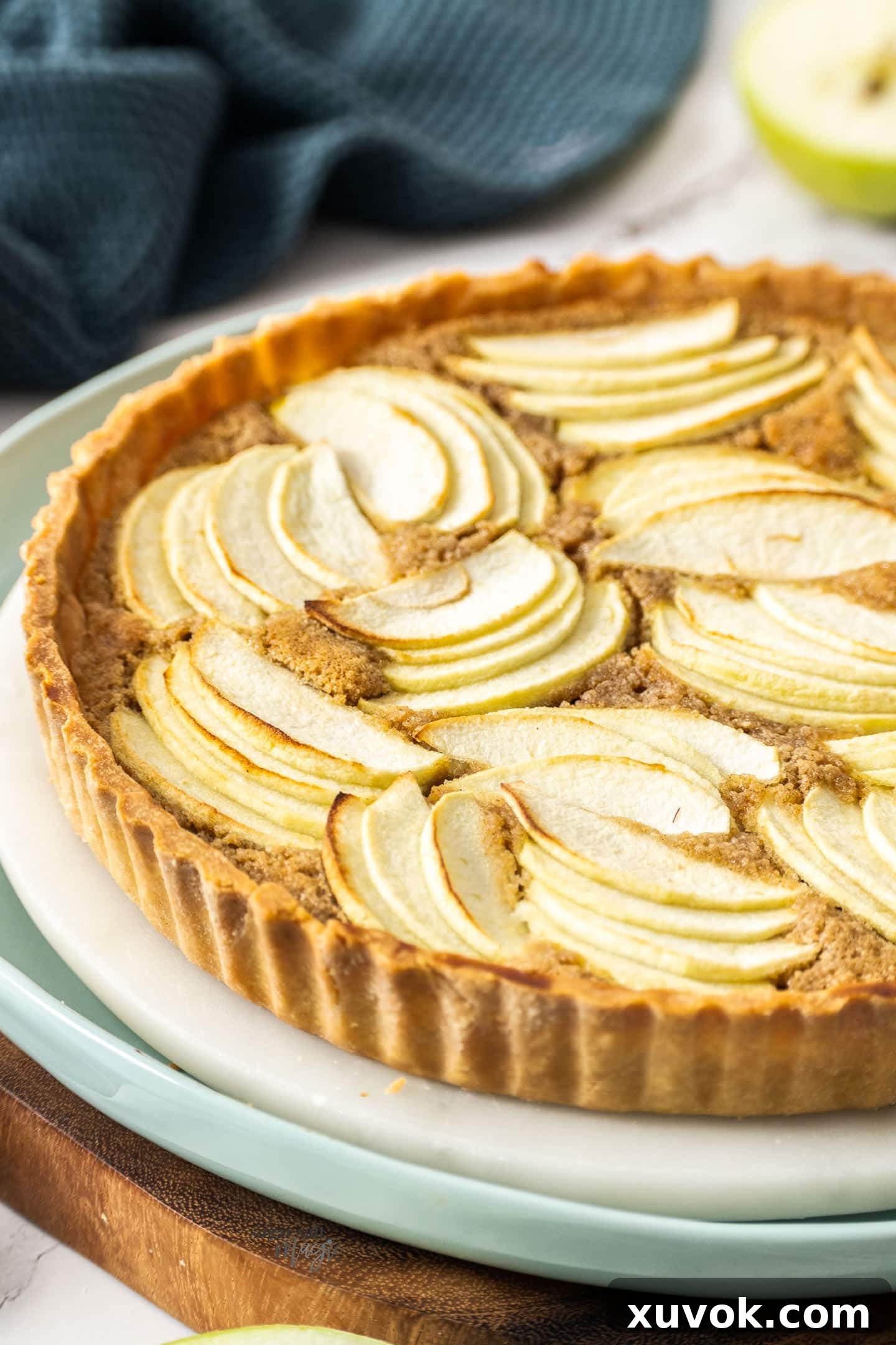 A close-up view of the perfectly arranged apple slices baked on top of the frangipane tart.