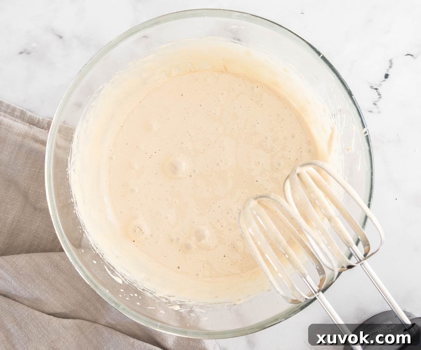 Eggs and sugar beaten together in a glass bowl until light and fluffy.