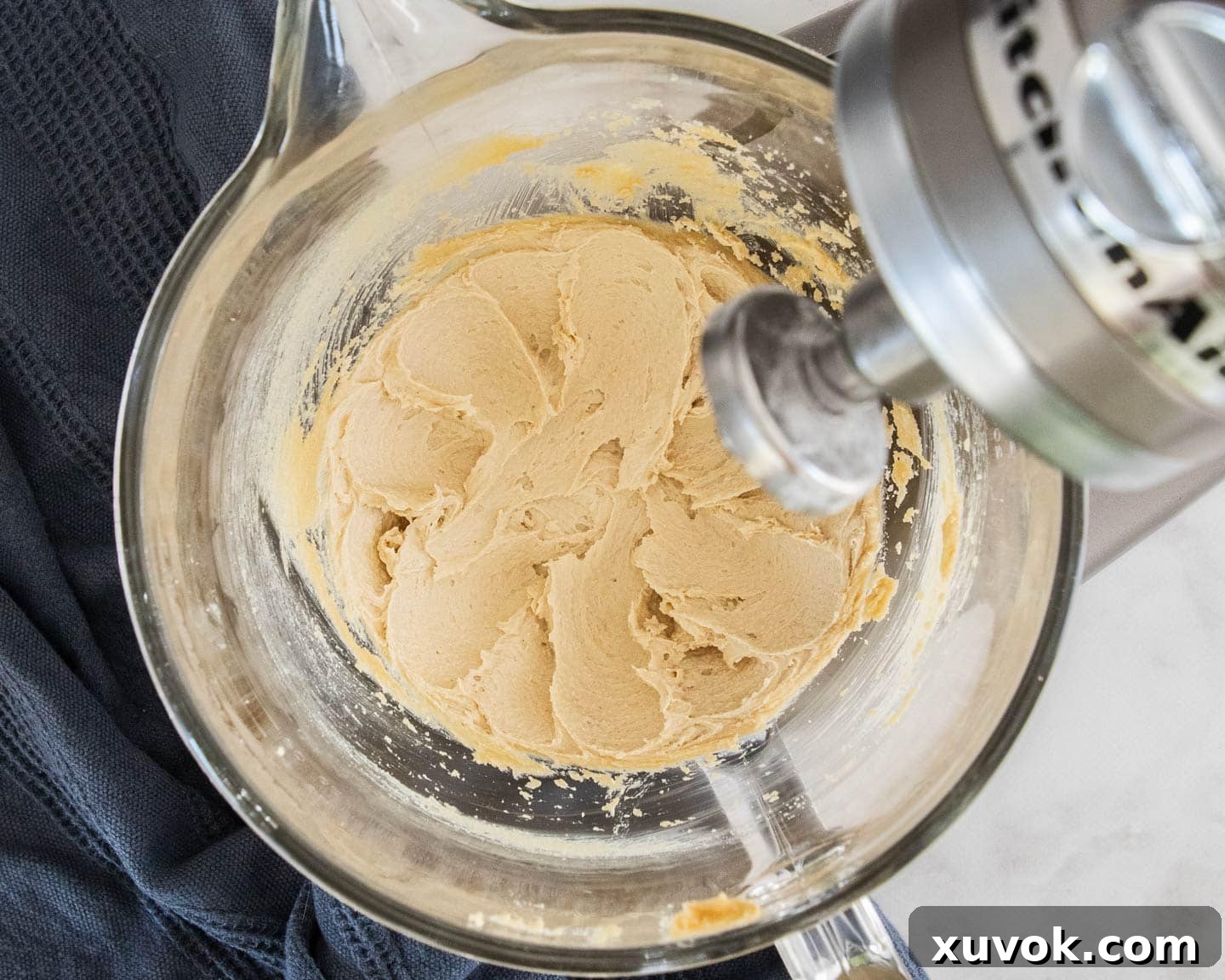 The butter and sugars creamed together in a mixing bowl.