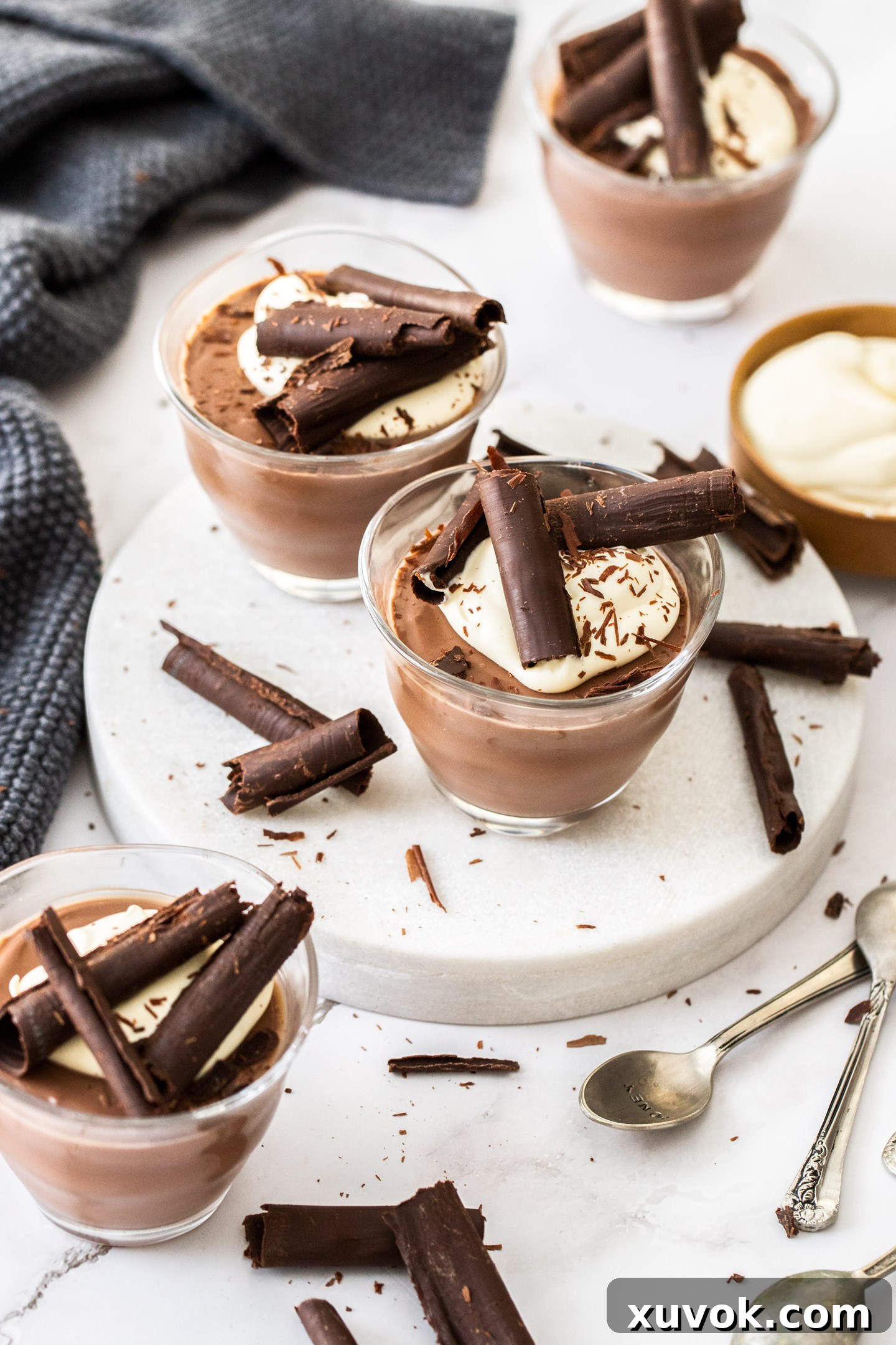 4 chocolate pots on a marble surface.