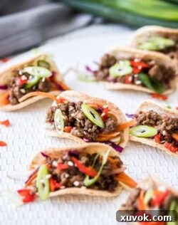 A batch of mini tacos filled with beef mince.