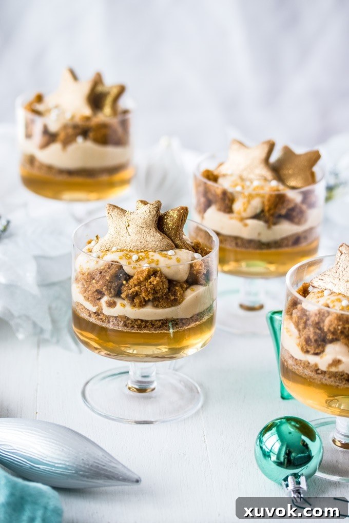Gingerbread Trifle in glass cups next to some Christmas ornaments. A festive and inviting display.