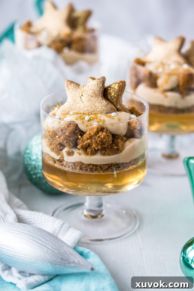 Closeup of Gingerbread Trifle, 2 more in the back, Christmas ornaments scattered around. Emphasizing the beautiful layers.