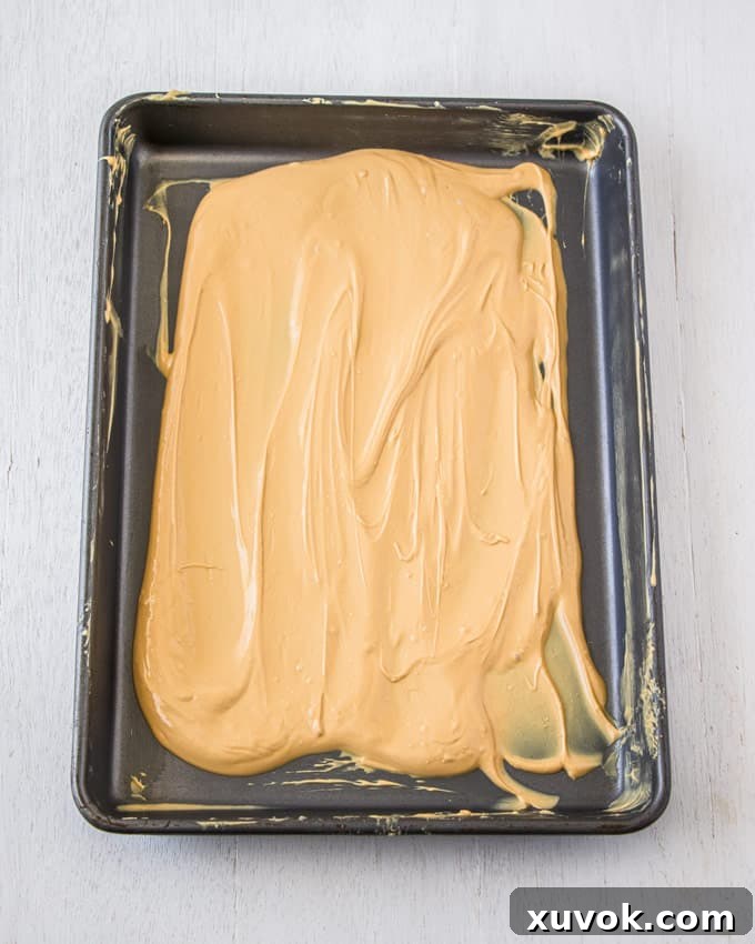 A baking tin covered in caramelised white chocolate, now a beautiful amber color.