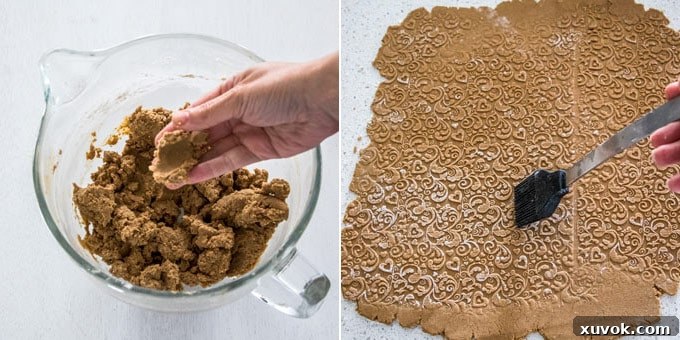 Embossed rolled out cookie dough with flour being brushed off