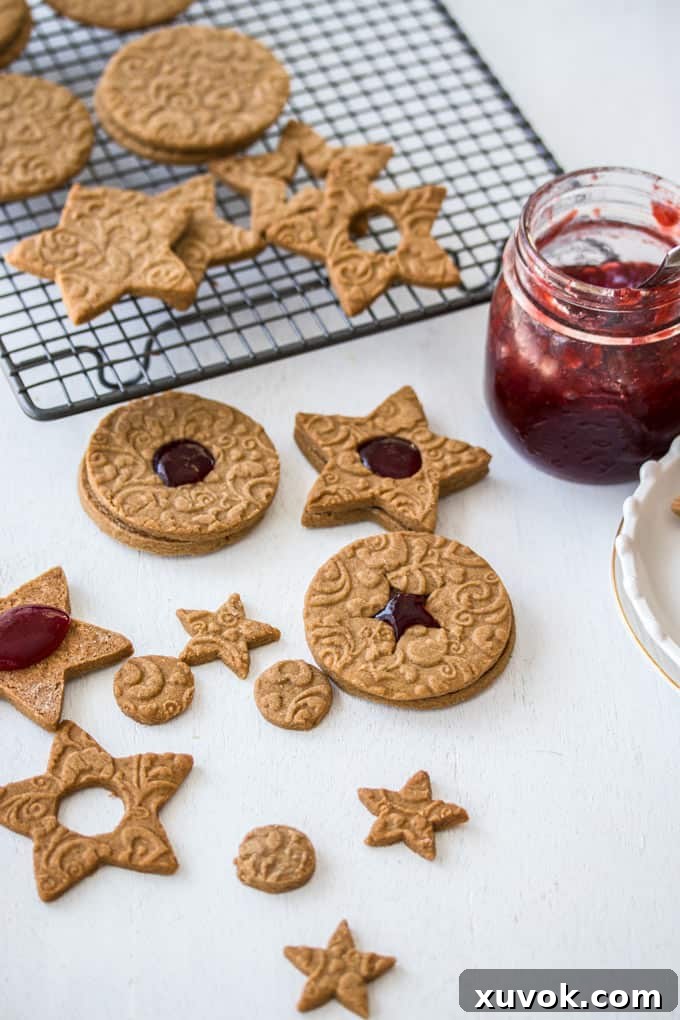 Cookies being filled with jam and topped with more cookies