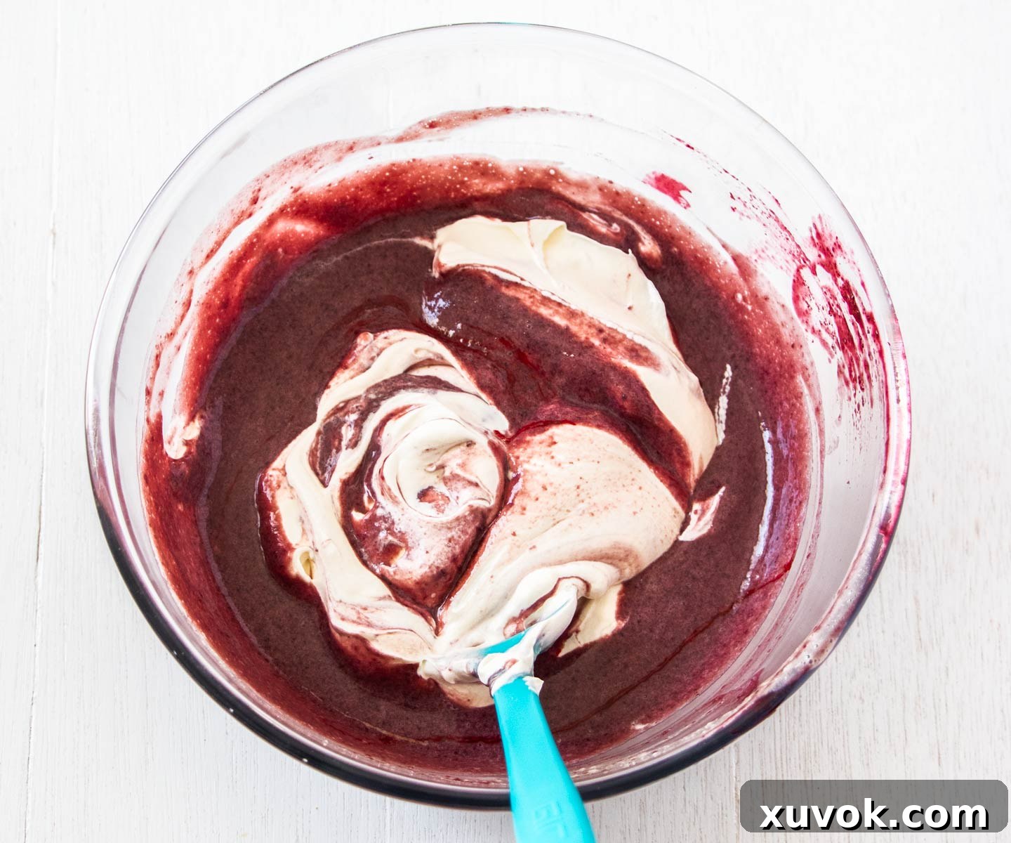 The cream being folded into the cherry portion.