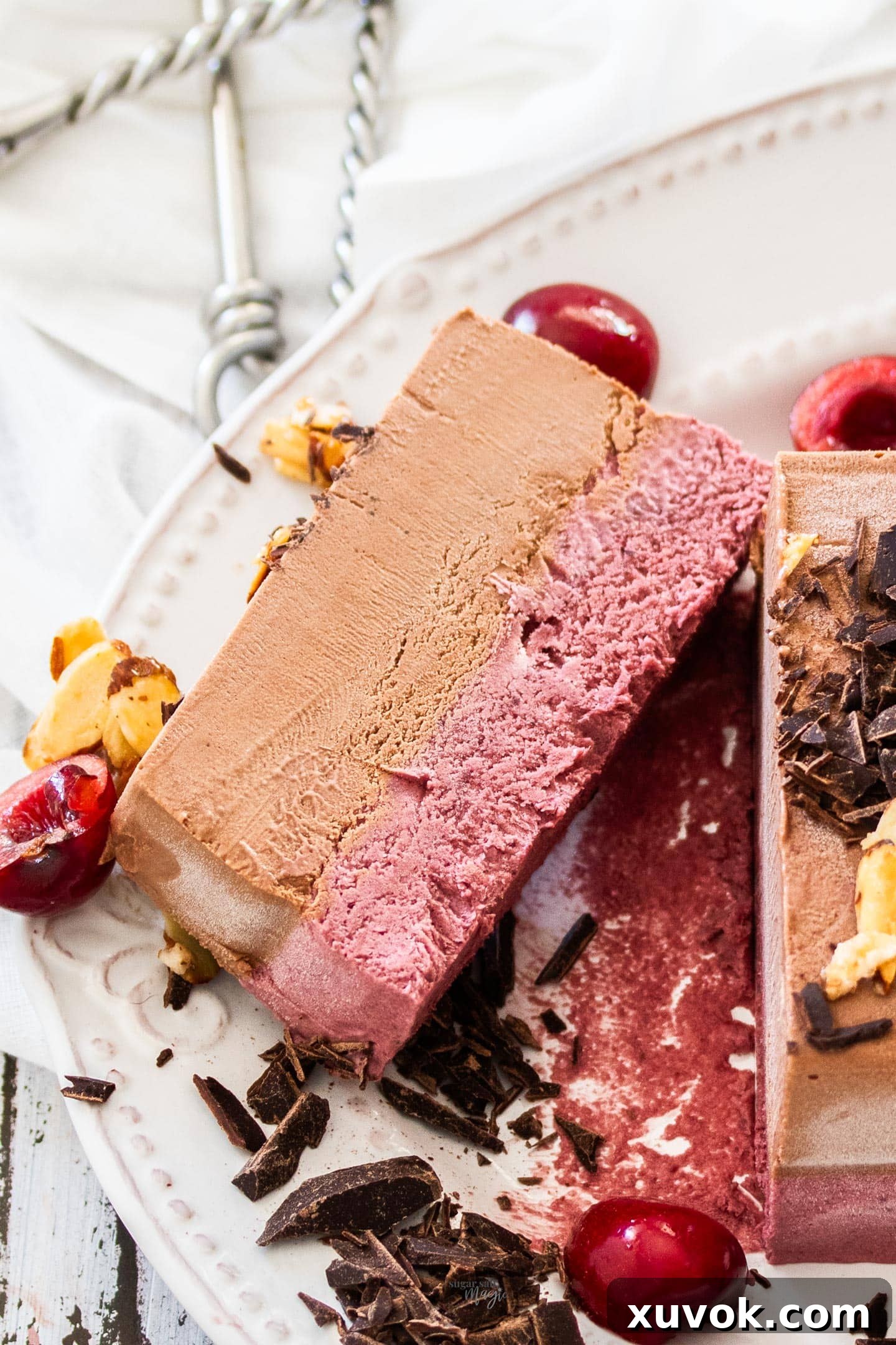 A slice of cherry chocolate frozen parfait on a serving dish.