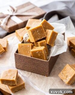 A bronze gift box filled with squares of salted caramel fudge.