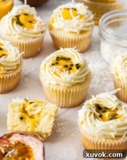 6 passionfruit cupcakes with half a passionfruit in front.