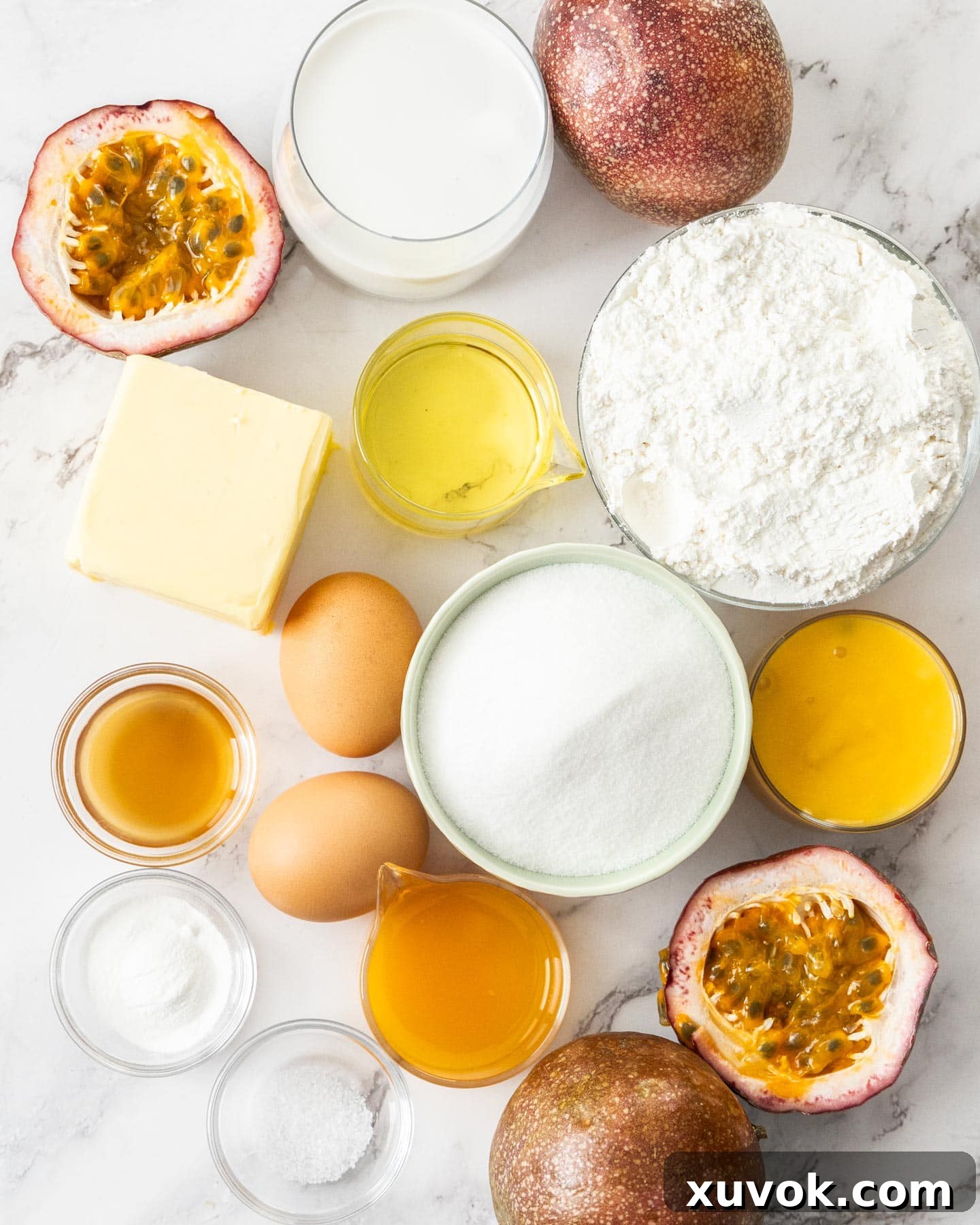 Ingredients for coconut passionfruit cupcakes laid out on a table, including eggs, flour, butter, coconut milk, and passionfruit pulp.