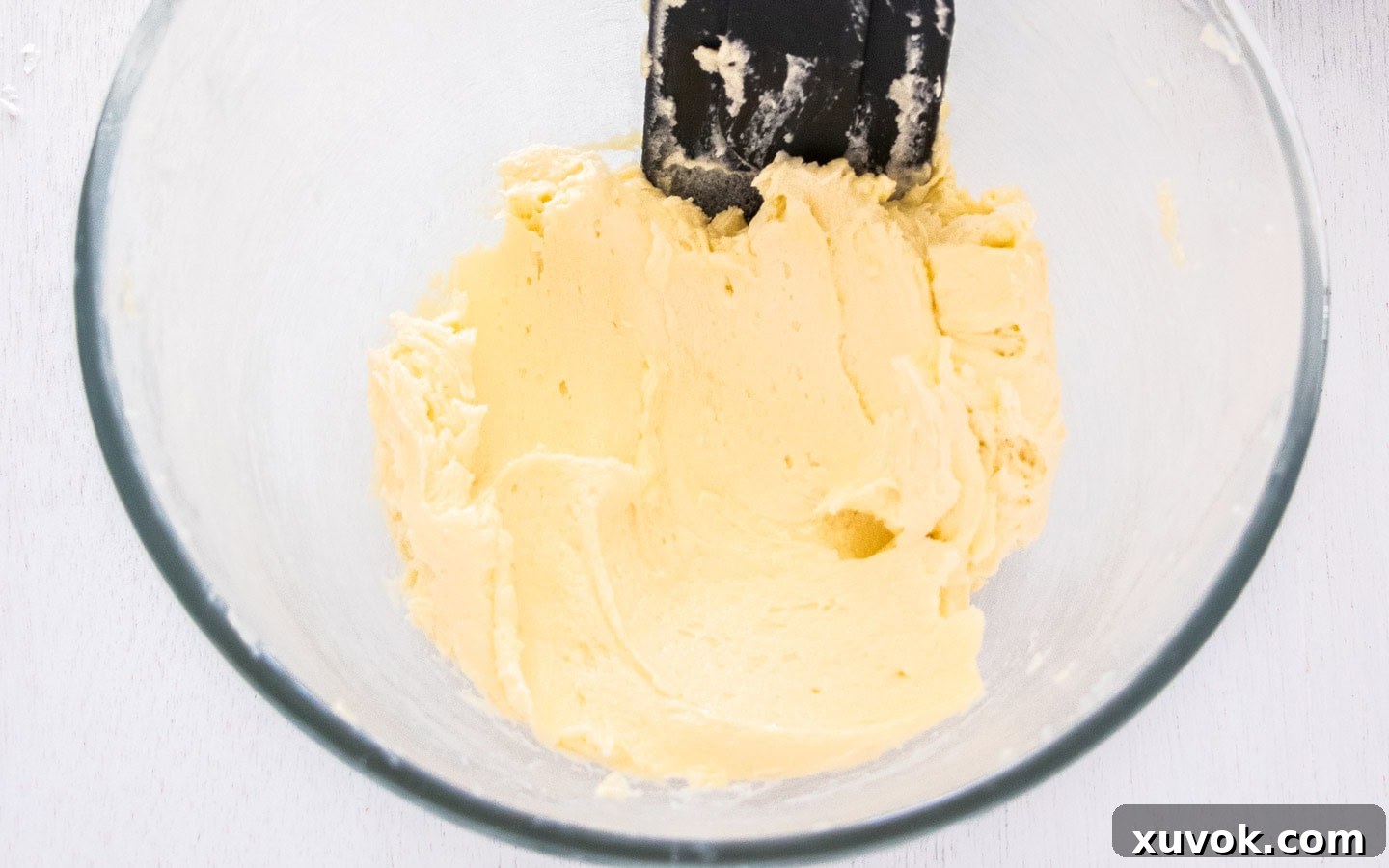 Butter and sugar creamed together in a bowl, a light and fluffy mixture.