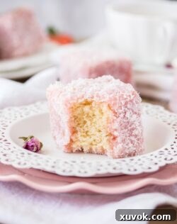 This Rose Strawberry Lamington recipe is a lovely twist on the classic Aussie Lamington. Pink lamingtons with a fluffy sponge centre and a homemade rose and strawberry jelly.