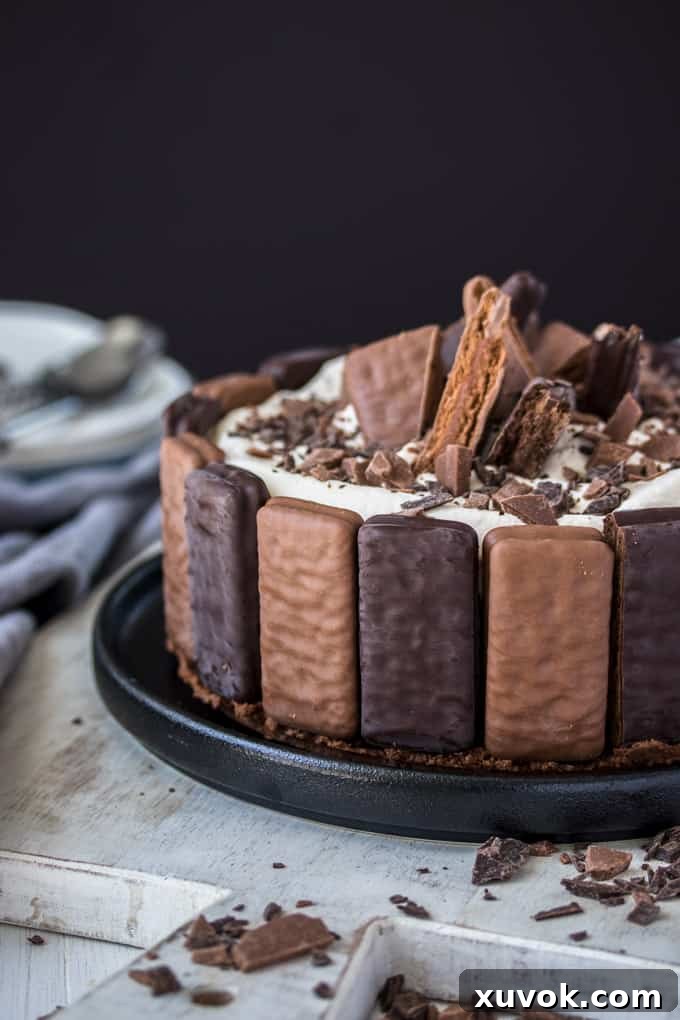 A No Bake Tim Tam Cheesecake with Tim Tams around the edges and pieces of Tim Tam on top