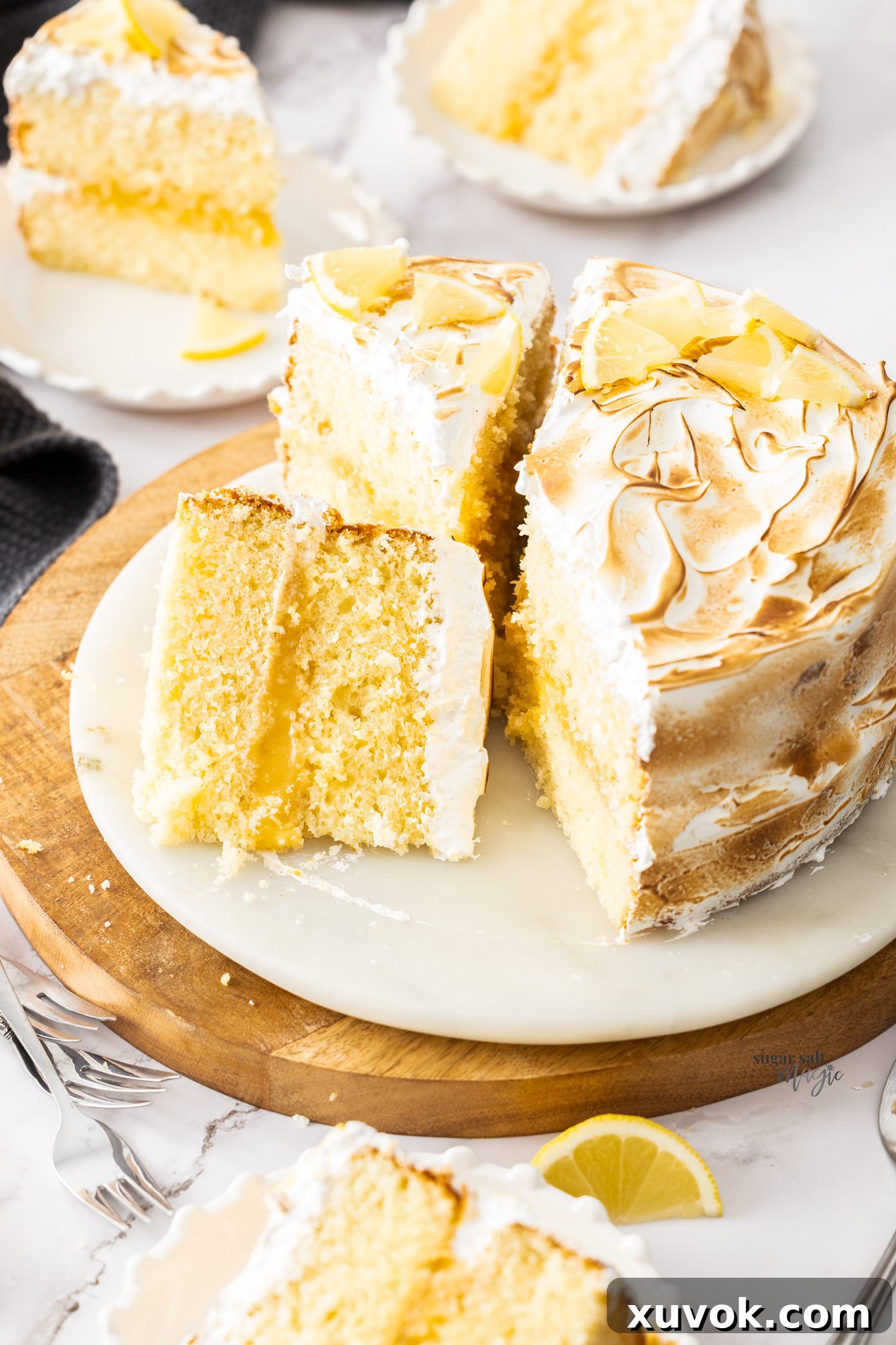 A stunning lemon meringue cake cut into inviting slices, showcasing its layers.