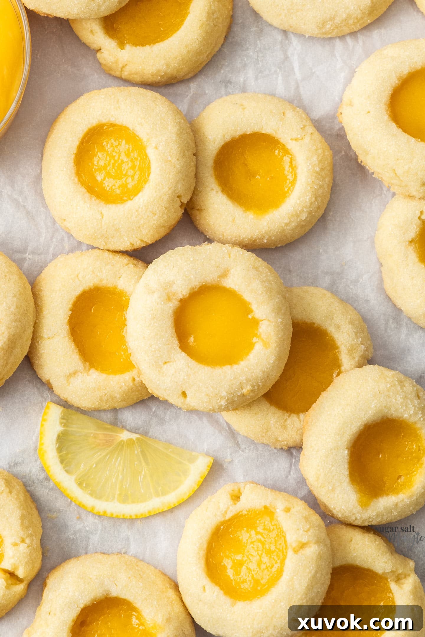 Closeup of soft, crumbly lemon curd cookies with a vibrant yellow filling.