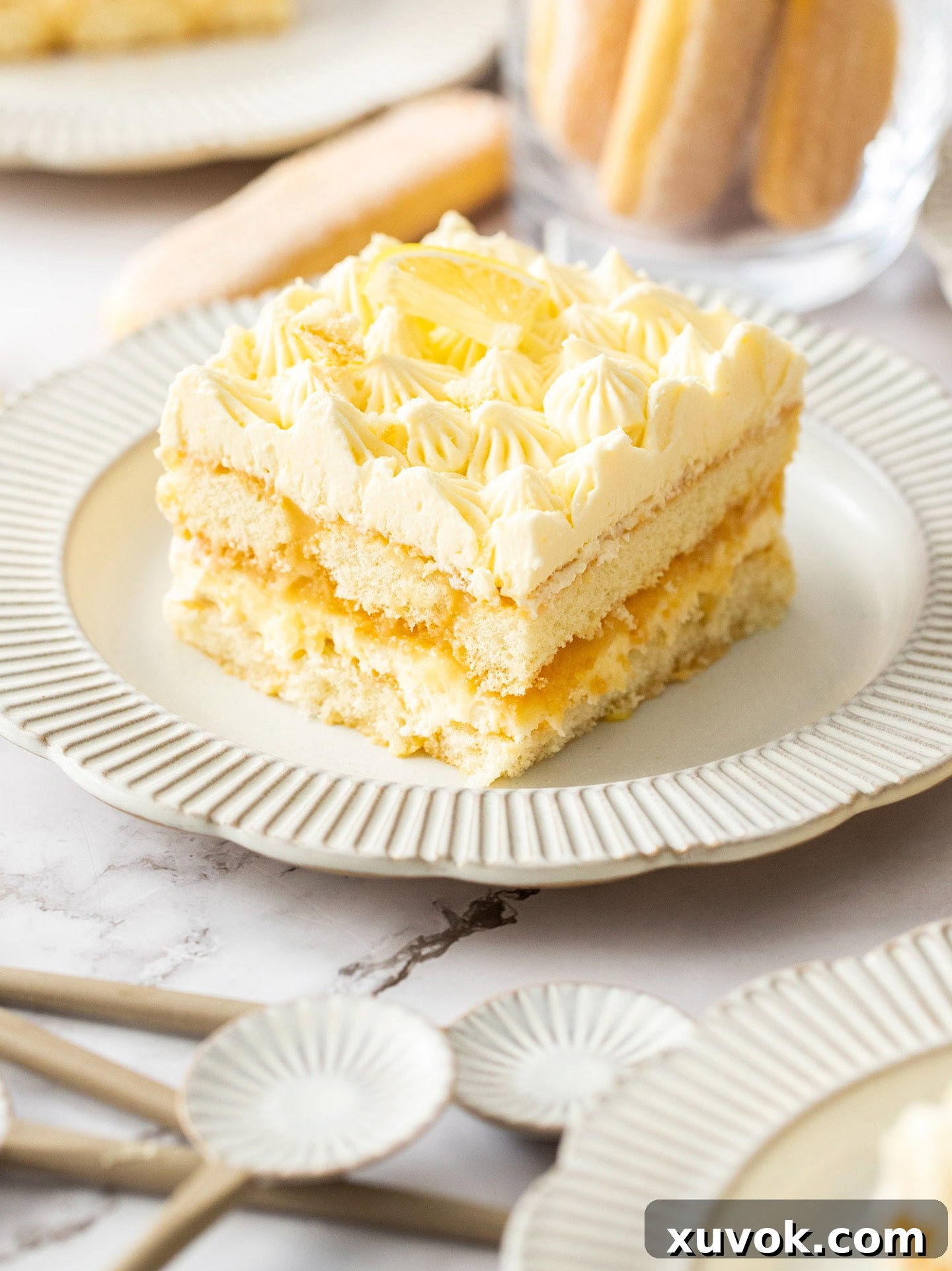 A delicate slice of lemon tiramisu on a dessert plate, showcasing its creamy layers.