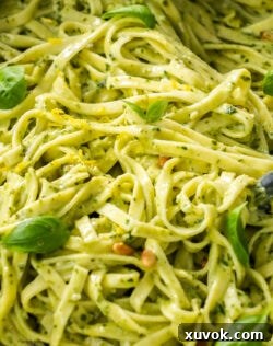 Extreme closeup of creamy pesto pasta.