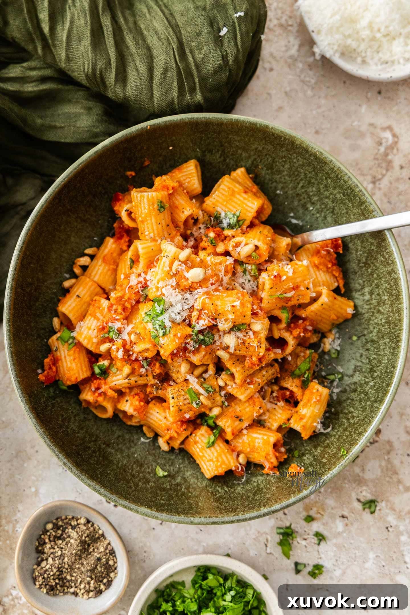 Top down view of a bowl of pasta in a sun dried tomato pesto sauce.